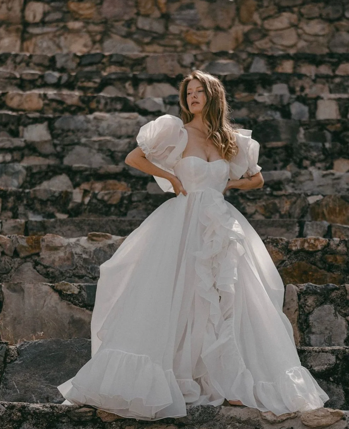 The Danielle Dress is everything you could dream of in a fantasy bridal gown. Enchanting, chic, and romantic, it will make you feel like a princess on your special day. The flowy design adds a touch of elegance, making it the perfect choice for a fairytale wedding. Say "I do" to the dress of your dreams.