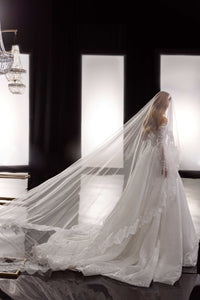 This Bernita Gown exudes elegance with its exquisite French lace and romantic allure. The accompanying veil adds a touch of chic and completes the bridal look. Perfect for any sophisticated bride seeking a timeless and refined wedding gown.