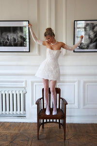 Experience the perfect combination of elegance and contemporary style with our Cameia Mini Dress. Featuring detachable sleeves and intricate lace details, this short wedding dress will make you feel like a princess. The corset back and zipper closure ensure a flawless fit, while the delicate lace adds a touch of romance.