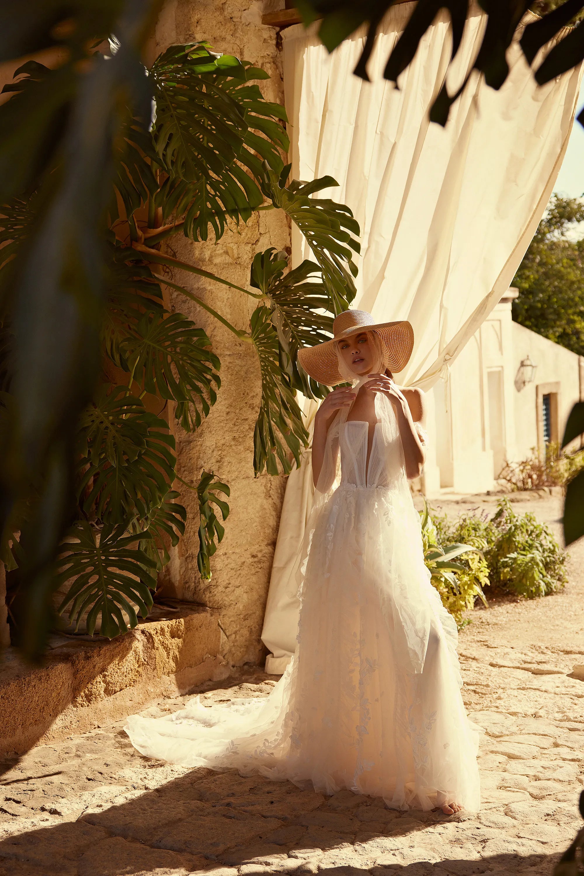 Channel your inner risk-taker on your big day with the one-of-a-kind Blossom Gown. Featuring delicate lace appliques that flow down the skirt and complete the train, this dress is perfect for the adventurous bride. The detachable straps add an extra touch of uniqueness to this bold and beautiful gown.