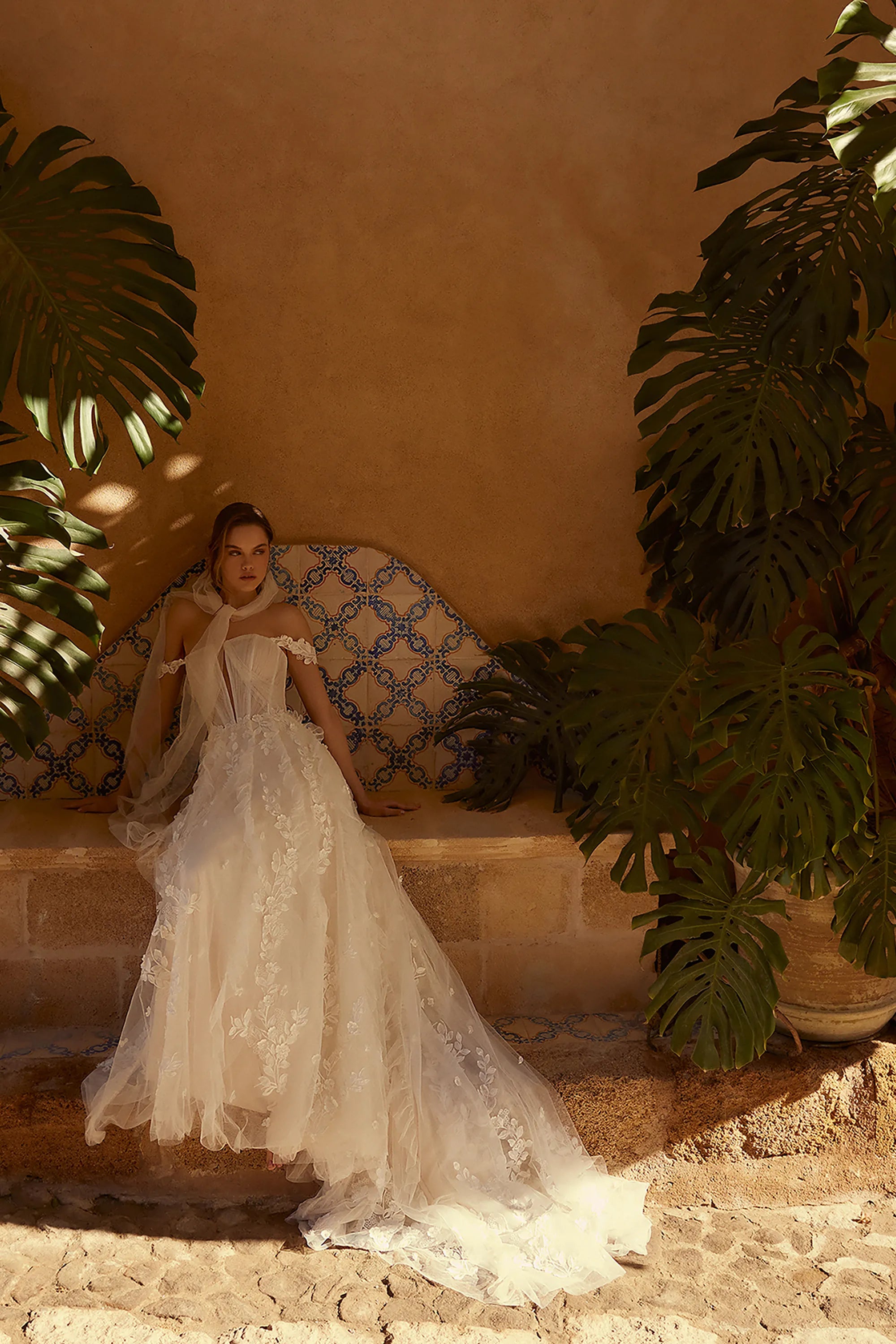 Channel your inner risk-taker on your big day with the one-of-a-kind Blossom Gown. Featuring delicate lace appliques that flow down the skirt and complete the train, this dress is perfect for the adventurous bride. The detachable straps add an extra touch of uniqueness to this bold and beautiful gown.