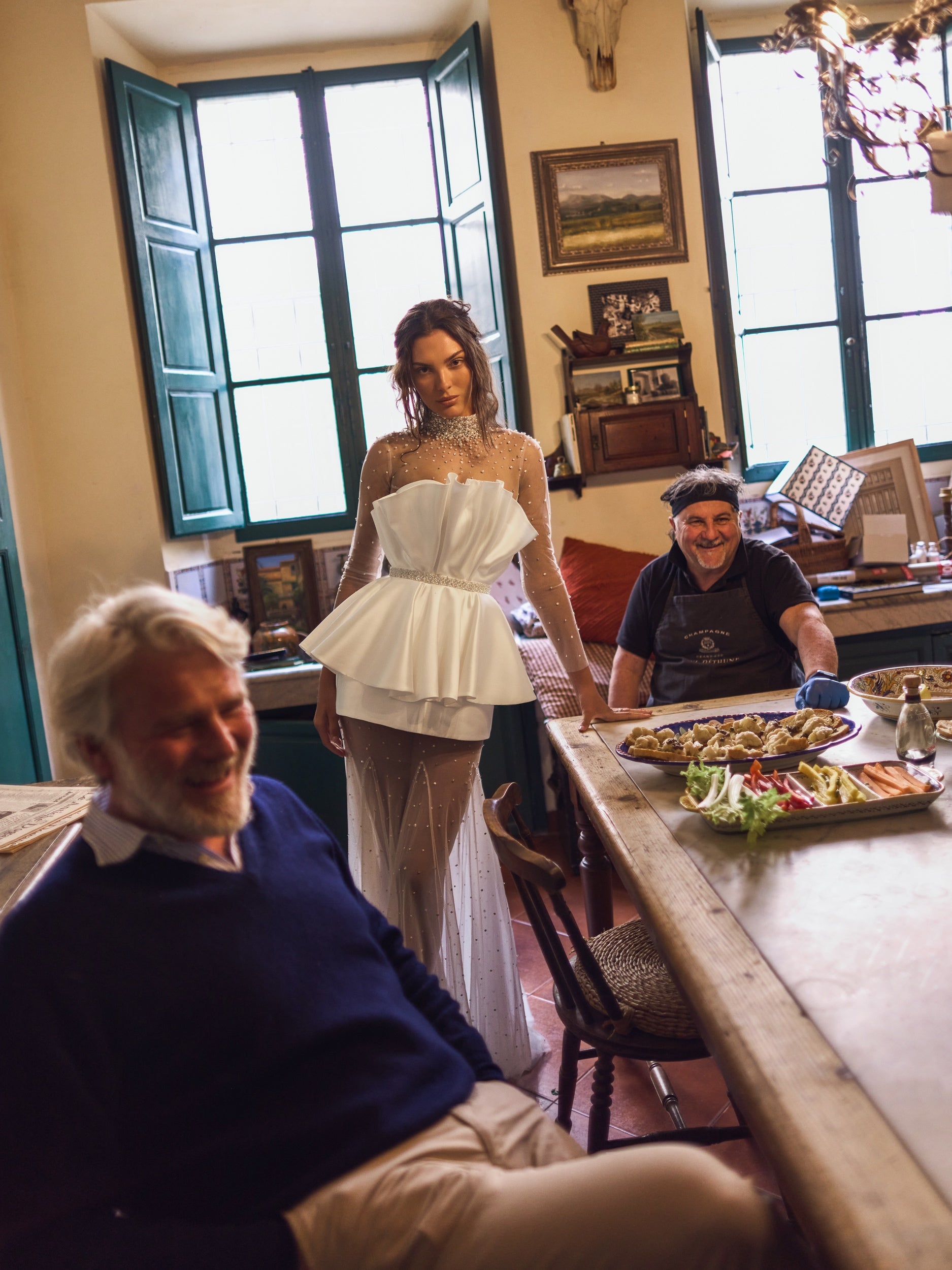 The Cassiopeia Gown captivates with its extraordinary seashell-inspired silhouette and radiant shimmer. Crafted from glossy mikado and crystal-embellished tulle, it features a neckline richly detailed with crystals and pearls for a sophisticated focal point. The bodice secures with hooks and a hidden snap at the waist, complemented by a matching embellished belt that defines the figure. 