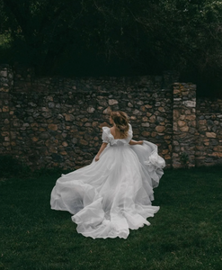 The Danielle Dress is everything you could dream of in a fantasy bridal gown. Enchanting, chic, and romantic, it will make you feel like a princess on your special day. The flowy design adds a touch of elegance, making it the perfect choice for a fairytale wedding. Say "I do" to the dress of your dreams.