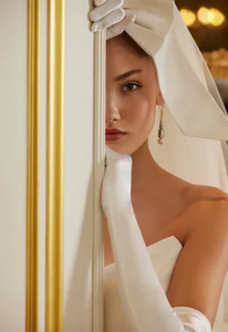 Luxurious and elegant, the Demia Gown is crafted from Italian Stretch Mikado fabric and features a cat eye neckline and basque waist for a flattering silhouette. The pleated and gathered ballgown is adorned with signature bow accents on the back bodice, making it a perfect pick for a special occasion.