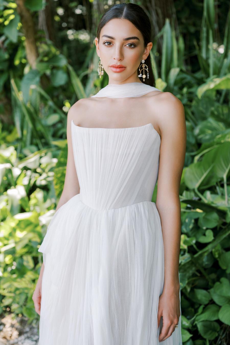 Introducing the Bridget Corset Gown, a modern twist on the timeless ballgown silhouette. With its soft net tie and Georgian-style corsetry, this gown exudes romance and structure. Delicate tucks add an element of intrigue, creating a unique and elegant creation that embodies contemporary style. Crafted from soft netting, the Bridget Corset Gown is a perfect blend of modern and classic design.