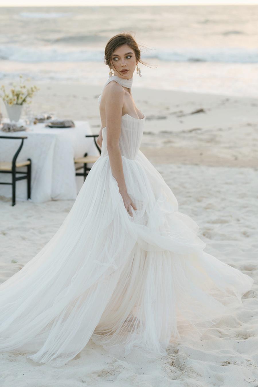 Introducing the Bridget Corset Gown, a modern twist on the timeless ballgown silhouette. With its soft net tie and Georgian-style corsetry, this gown exudes romance and structure. Delicate tucks add an element of intrigue, creating a unique and elegant creation that embodies contemporary style. Crafted from soft netting, the Bridget Corset Gown is a perfect blend of modern and classic design.