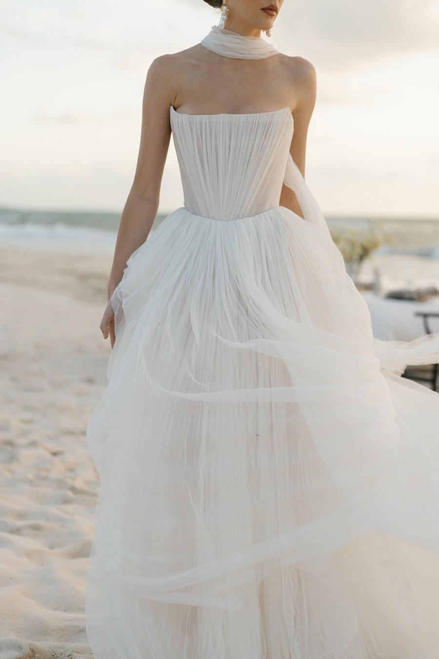 Introducing the Bridget Corset Gown, a modern twist on the timeless ballgown silhouette. With its soft net tie and Georgian-style corsetry, this gown exudes romance and structure. Delicate tucks add an element of intrigue, creating a unique and elegant creation that embodies contemporary style. Crafted from soft netting, the Bridget Corset Gown is a perfect blend of modern and classic design.