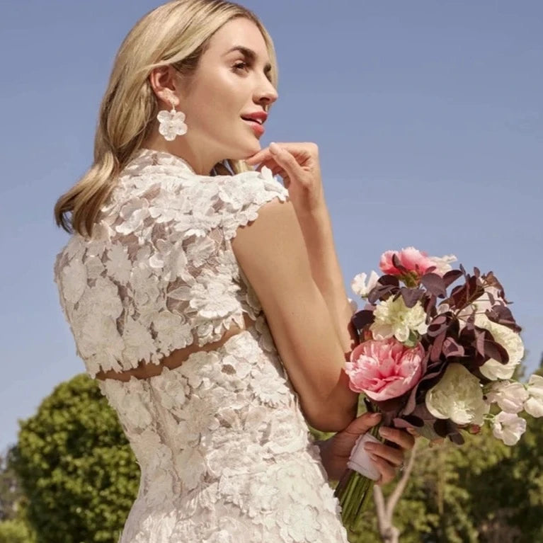 This strapless wedding dress is the epitome of elegance and sophistication. The delicate applique adds a touch of femininity, while the A-line design is both flattering and comfortable. With a high-quality construction and mini length, the Civil Robe Delancey is perfect for any bride's special day. Say "I do" to this beautiful dress.