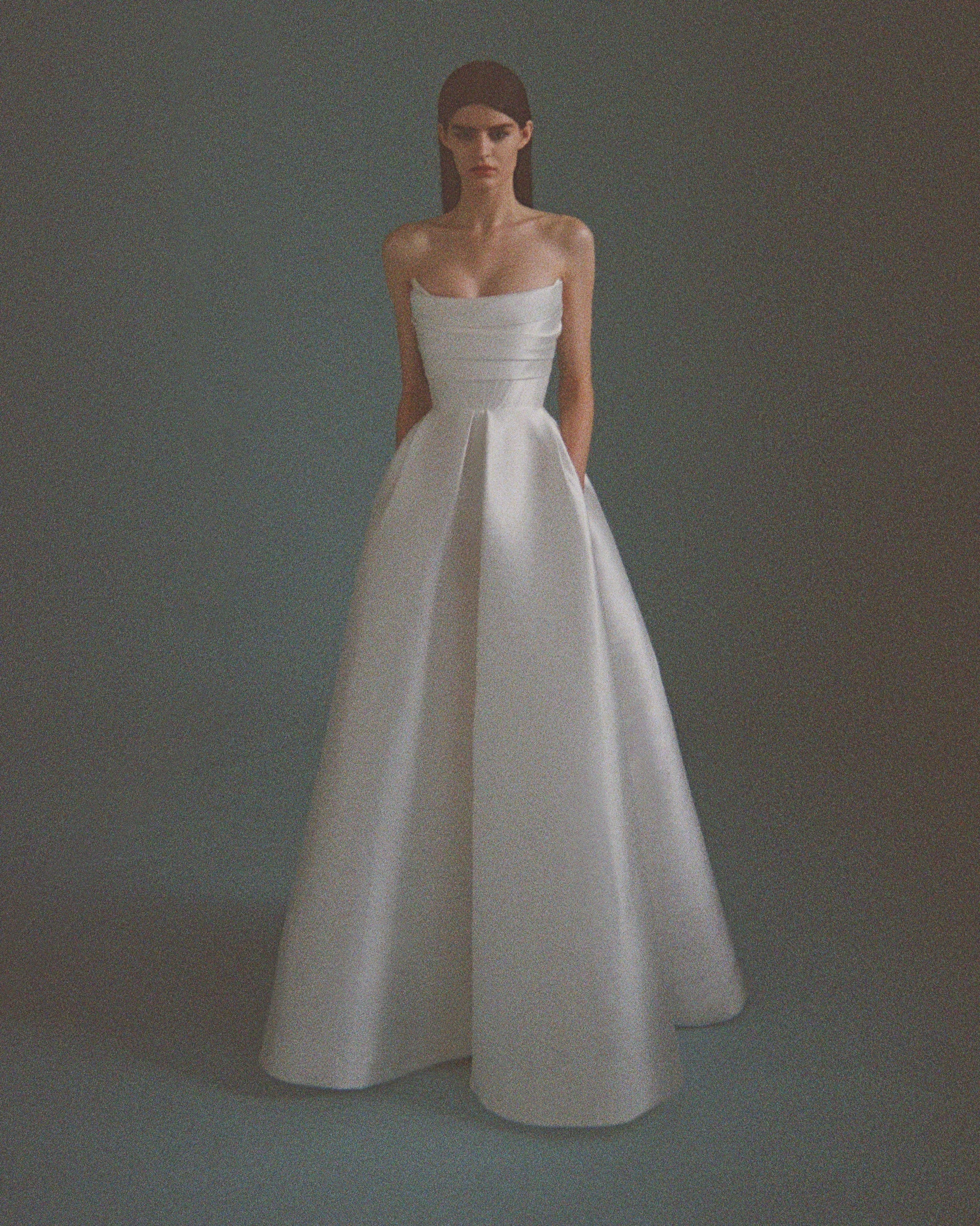 'Isobel' gown is such an elegant choice for your special day. Crafted from white satin-faille with a lustrous finish, it has the signature sculptural bodice and a full skirt with pleats that add structure and volume.