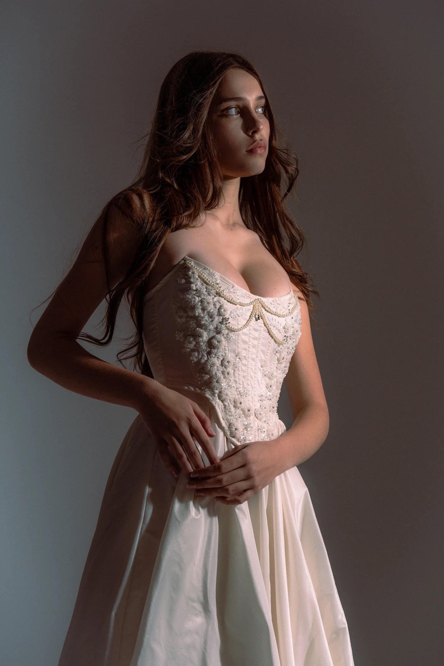 Indulge in elegance and comfort with the Katherine Gown. Adorned with exquisite beaded appliqués, the taffeta corset ensures a flawless fit, while the lined leg slit skirt adds a touch of refinement. Step out in style and radiate beauty with each stride.