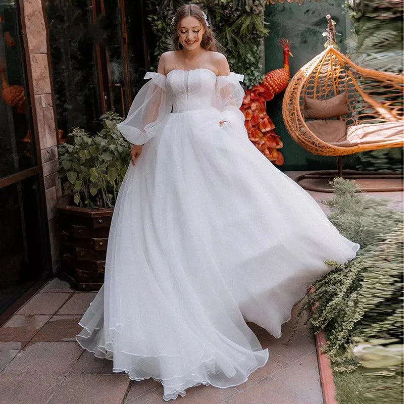 Robe Oriane is the perfect princess wedding dress for any bride-to-be. Featuring a strapless design and puff long sleeves, this gown exudes elegance and grace. The off-shoulder court train adds a touch of luxury, while the organza material provides a simple and sophisticated look. Feel like royalty on your special day with this stunning bridal gown.