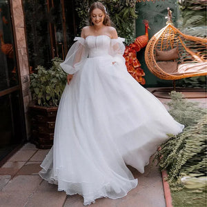 Robe Oriane is the perfect princess wedding dress for any bride-to-be. Featuring a strapless design and puff long sleeves, this gown exudes elegance and grace. The off-shoulder court train adds a touch of luxury, while the organza material provides a simple and sophisticated look. Feel like royalty on your special day with this stunning bridal gown.