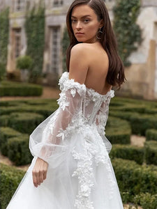 The Robe Capriana features a beautiful combination of cap sleeves and strapless design, creating a stunning wedding dress. Intricate appliques adorn the organza material, with a long court train and a backless silhouette adding elegance and charm. Perfect for a stylish and modern bride.