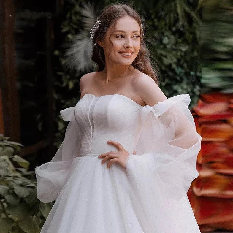 Robe Oriane is the perfect princess wedding dress for any bride-to-be. Featuring a strapless design and puff long sleeves, this gown exudes elegance and grace. The off-shoulder court train adds a touch of luxury, while the organza material provides a simple and sophisticated look. Feel like royalty on your special day with this stunning bridal gown.