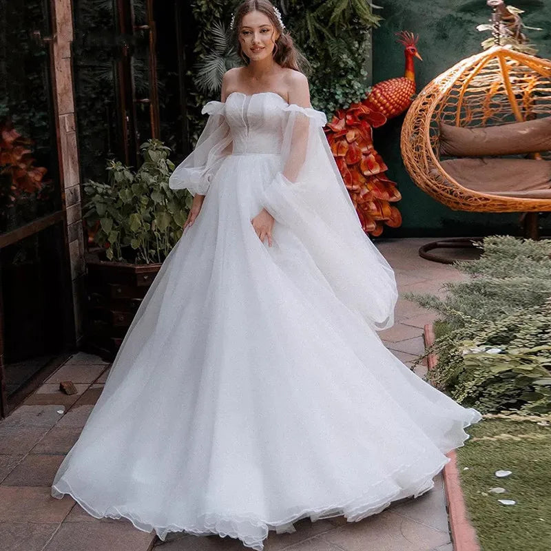 Robe Oriane is the perfect princess wedding dress for any bride-to-be. Featuring a strapless design and puff long sleeves, this gown exudes elegance and grace. The off-shoulder court train adds a touch of luxury, while the organza material provides a simple and sophisticated look. Feel like royalty on your special day with this stunning bridal gown.