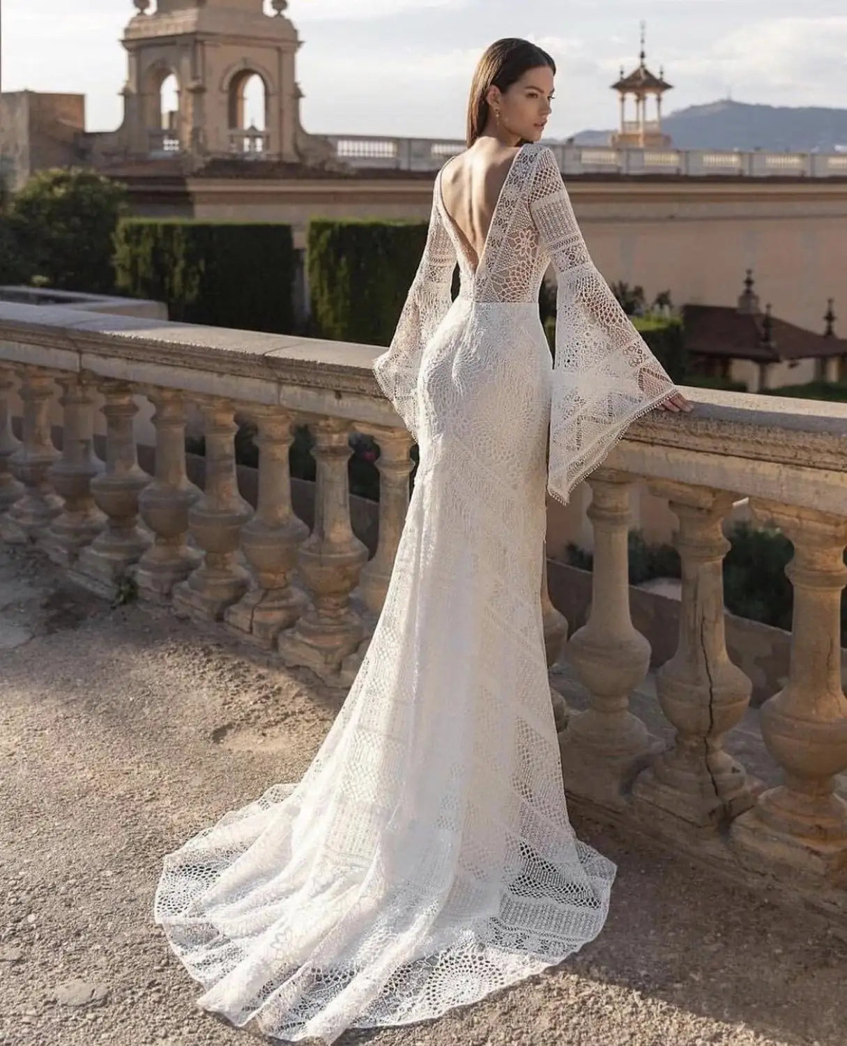 Be the boho bride of your dreams in our Robe Sherryl wedding dress! With a flirty v-neck, elegant flare sleeves, and stunning lace appliques, this mermaid gown will turn heads. Custom made and featuring a backless design and sweeping train, it's the perfect combination of comfort and wow factor. Live out your fairytale in style. (All hail the boho queen!)