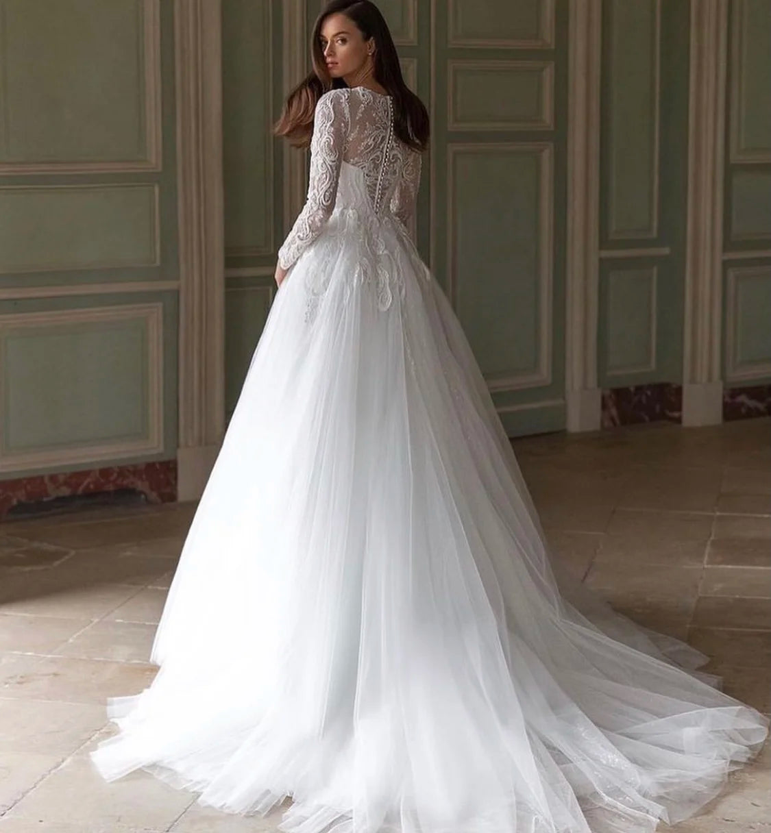 Unleash your fearless spirit with the Robe Lynette. This vintage lace wedding dress boasts a dramatic A-line silhouette, full sleeves, and delicate lace appliques adorned with sparkling sequins and beads. With a daring O-neckline and sweeping train, this dress is perfect for the adventurous bride ready to take on anything!
