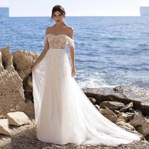 The Robe Juliet adds a touch of elegance to any bridal gown with its backless design and flowing tulle court train. The sashes add a unique detail to complete the look. Made with high-quality materials, this gown is perfect for any wedding.