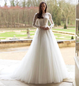 Unleash your fearless spirit with the Robe Lynette. This vintage lace wedding dress boasts a dramatic A-line silhouette, full sleeves, and delicate lace appliques adorned with sparkling sequins and beads. With a daring O-neckline and sweeping train, this dress is perfect for the adventurous bride ready to take on anything!