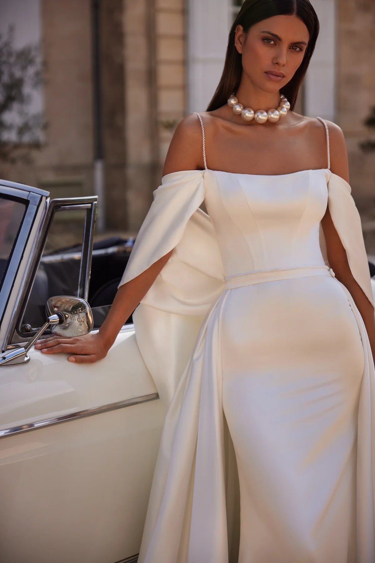 The Nadine Gown is the epitome of elegance and sophistication, a charming mermaid-cut wedding dress. Crafted from luxurious stretch satin, the fitted bodice with delicate embroidered straps and straight neckline accentuates your natural beauty. With a zipper closure and internal lacing for a perfect fit, a slim embroidered belt cinches the waist for a flattering silhouette. Walk down the aisle in graceful style with this exquisite gown.