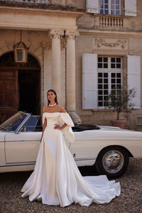 The Nadine Gown is the epitome of elegance and sophistication, a charming mermaid-cut wedding dress. Crafted from luxurious stretch satin, the fitted bodice with delicate embroidered straps and straight neckline accentuates your natural beauty. With a zipper closure and internal lacing for a perfect fit, a slim embroidered belt cinches the waist for a flattering silhouette. Walk down the aisle in graceful style with this exquisite gown.