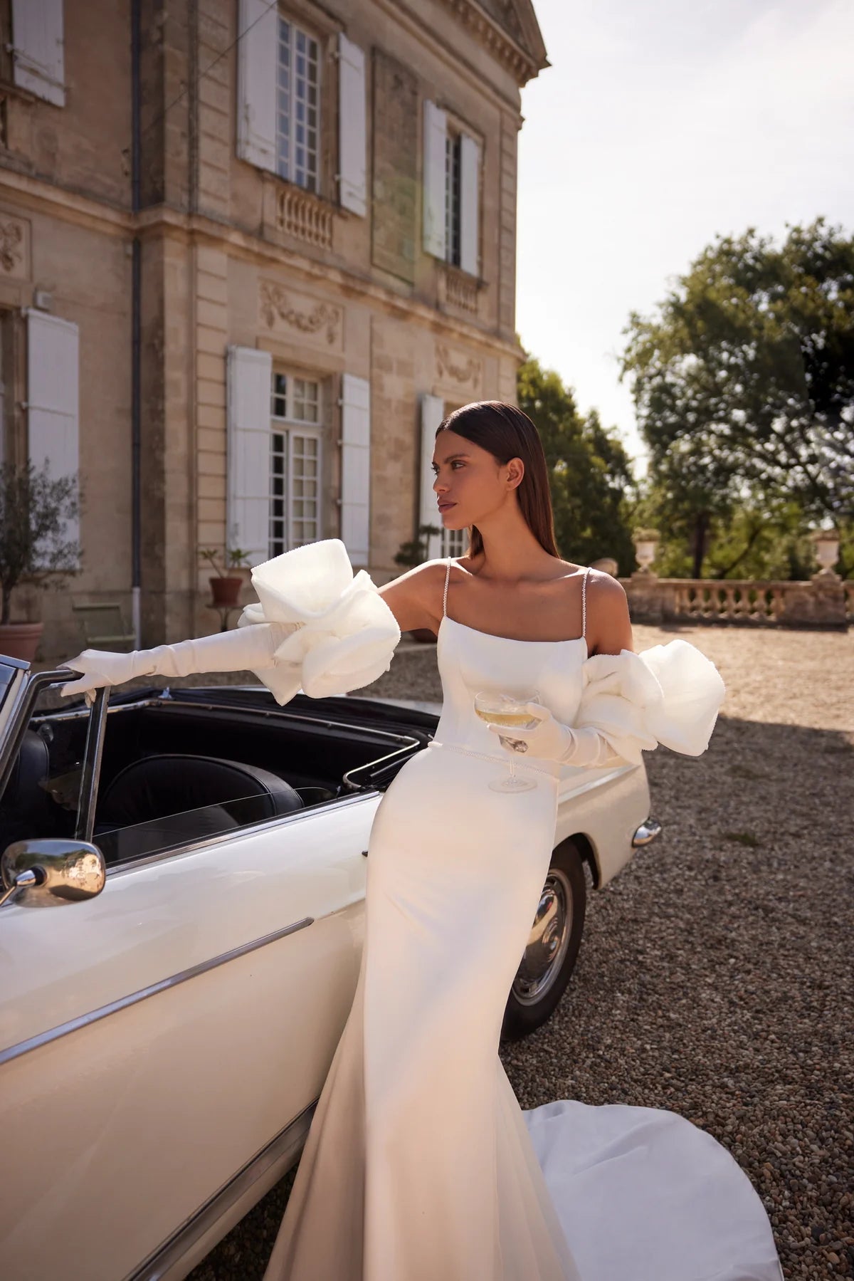 The Nadine Gown is the epitome of elegance and sophistication, a charming mermaid-cut wedding dress. Crafted from luxurious stretch satin, the fitted bodice with delicate embroidered straps and straight neckline accentuates your natural beauty. With a zipper closure and internal lacing for a perfect fit, a slim embroidered belt cinches the waist for a flattering silhouette. Walk down the aisle in graceful style with this exquisite gown.