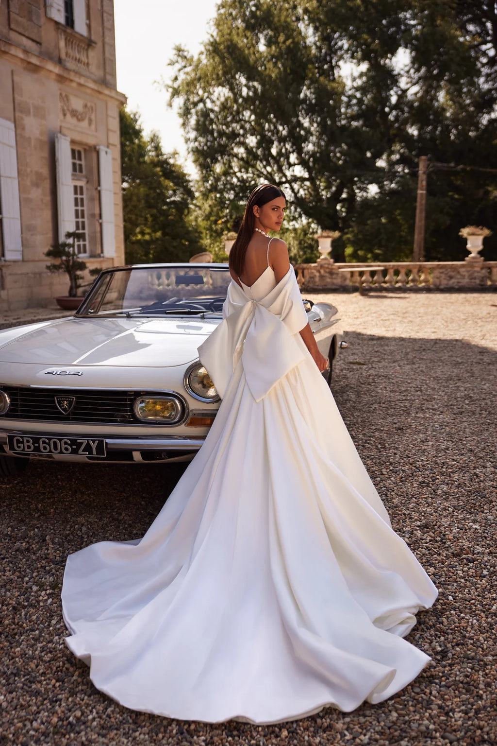 The Nadine Gown is the epitome of elegance and sophistication, a charming mermaid-cut wedding dress. Crafted from luxurious stretch satin, the fitted bodice with delicate embroidered straps and straight neckline accentuates your natural beauty. With a zipper closure and internal lacing for a perfect fit, a slim embroidered belt cinches the waist for a flattering silhouette. Walk down the aisle in graceful style with this exquisite gown.