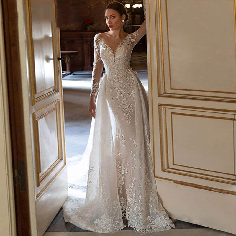 Be the talk of the aisle in this luxurious, vintage-style Harriett Dress. Crafted from exquisite embroidered lace and net with a detachable train, this statement gown features a V-neck sleeveless silhouette to exude sophistication and femininity. Perfect for a one-of-a-kind wedding look with timeless grace, the Harriett Dress is a special and exclusive choice.