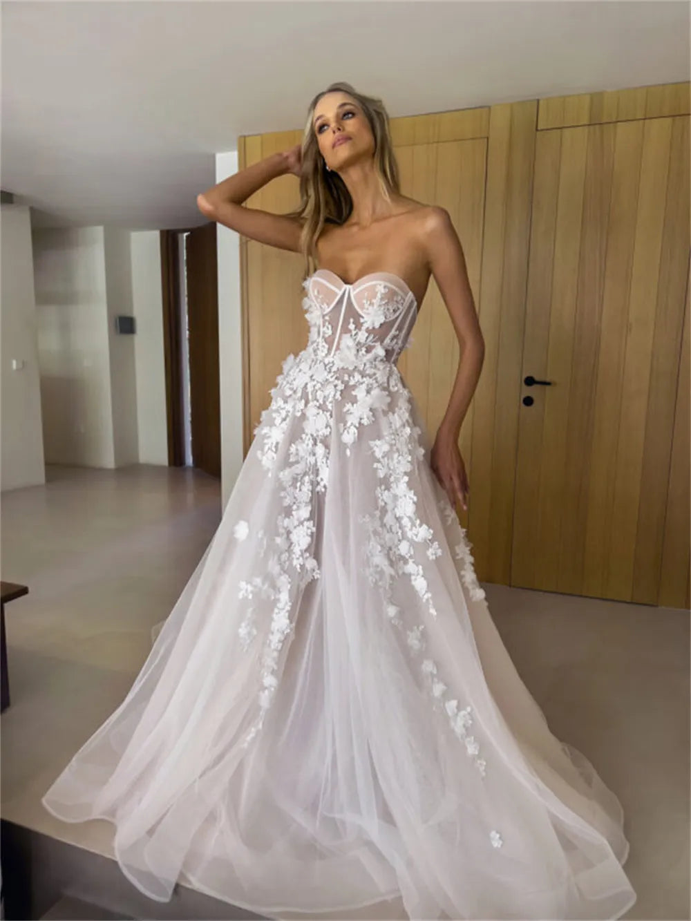 Enhance your special day with our Robe Eva. This stunning wedding dress features a flattering sweetheart neckline and elegant sleeveless design, giving you a timeless A-line silhouette. Adorned with delicate flowers, this bridal gown will make you feel like a beautiful bride on your big day.