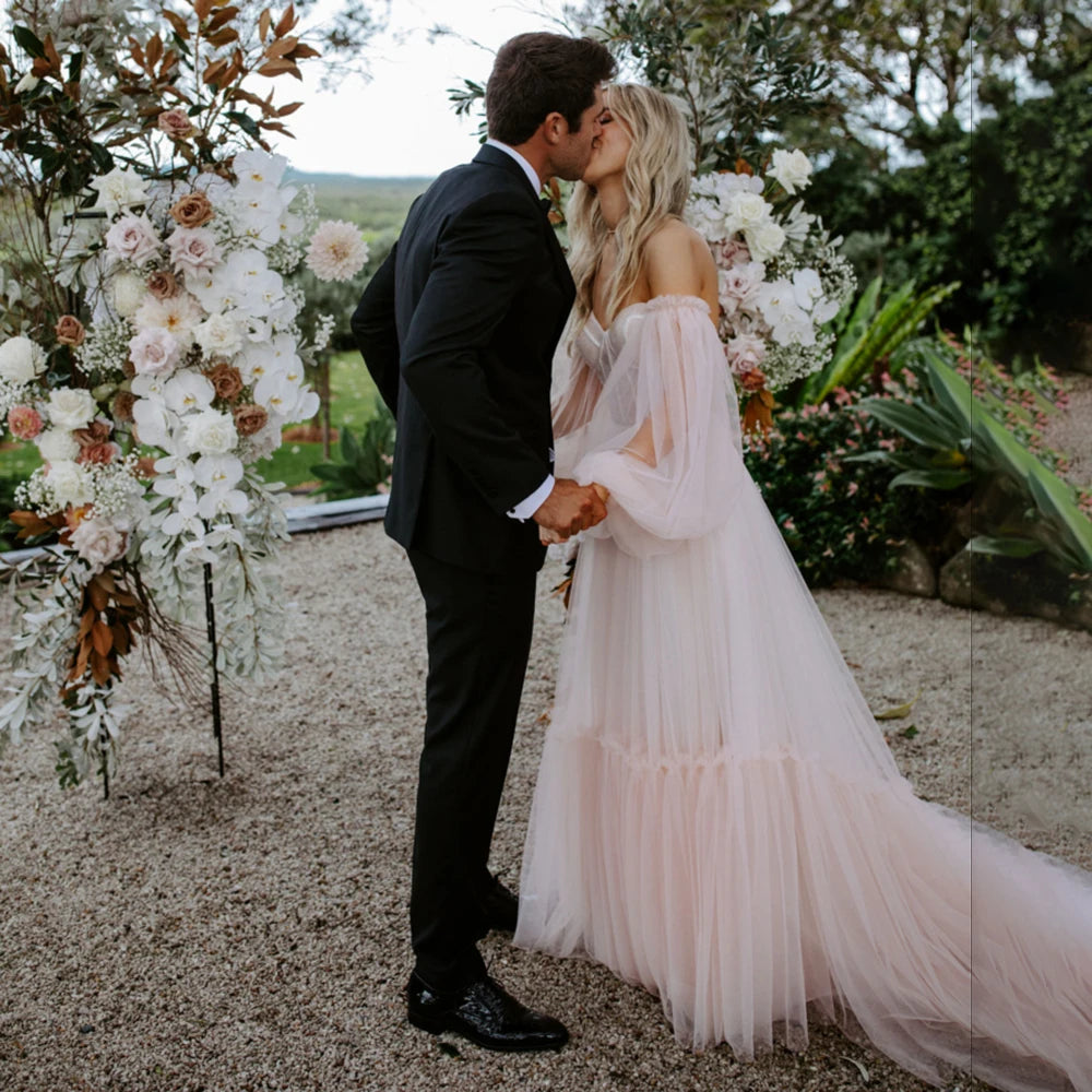 Make a statement in the Robe Amalie! This bold wedding gown features princess sweetheart neckline, long bishop sleeves, boning, lace overlay, and a tulle skirt for a look that'll take your breath away. Step into this dress with confidence and get ready to make your own fairy tale.