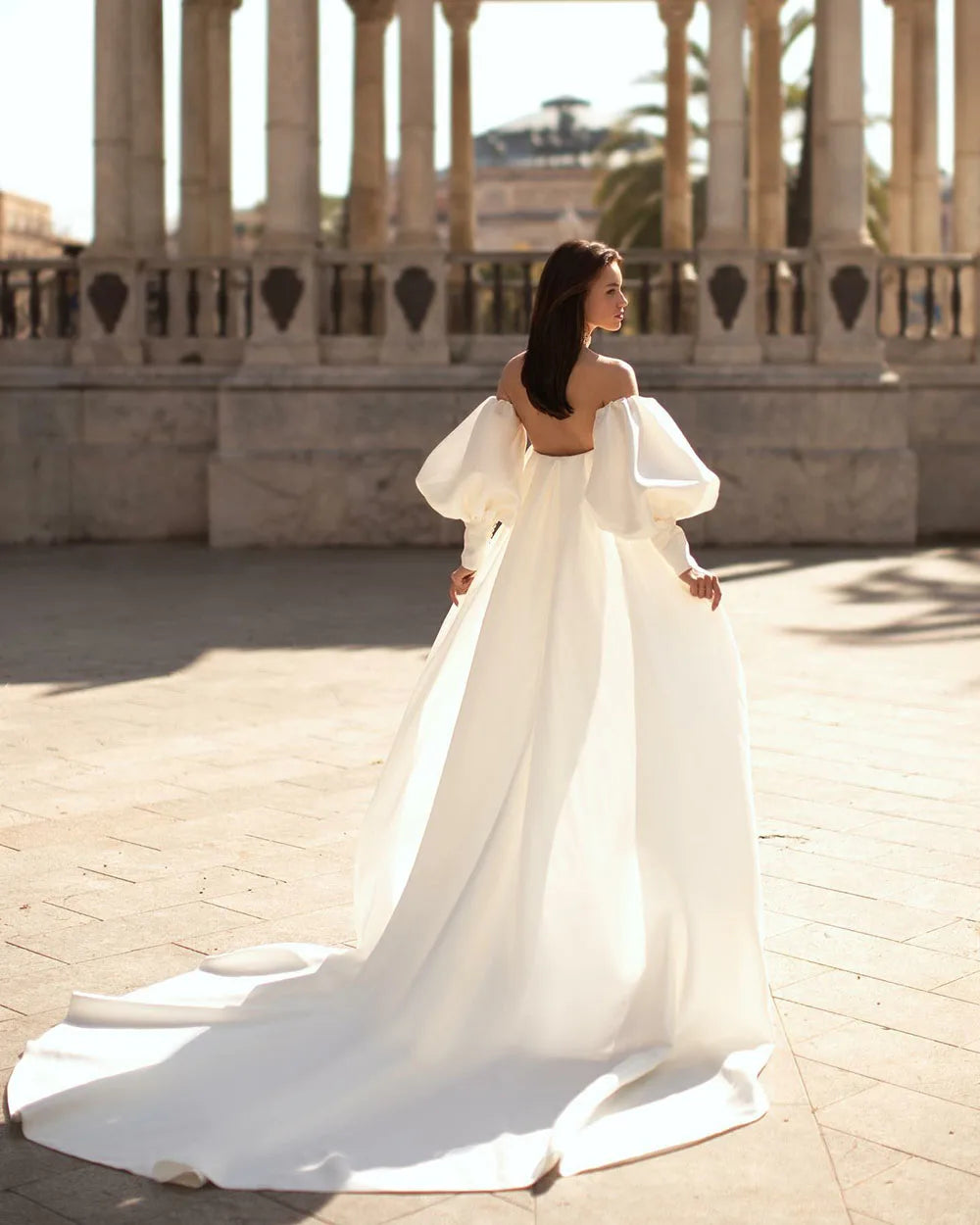 Experience the ultimate luxury with our beautifully crafted Robe Sandrine. Made with soft and silky satin, this wedding dress features a detachable train, perfect for a versatile and effortless look. The off the shoulder neckline and puff sleeves add a touch of romance and sophistication. Elevate your bridal experience with our Robe Sandrine.