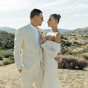 Introducing the Robe Rochelle - the perfect blend of sleek and elegant. With its long sleeves and dropped off shoulder design, this satin wedding dress exudes a simple yet glamorous vibe. Custom made to ensure a glossy finish, this dress is bound to make you shine on your special day.