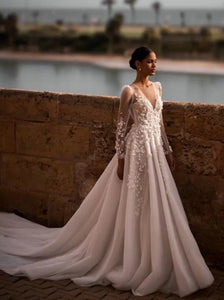 Indulge in timeless elegance with our Robe Nina. Featuring a delicately crafted lace design and long sleeves, this wedding gown is the perfect choice for your special day. Experience the luxury and sophistication of our exclusive collection.