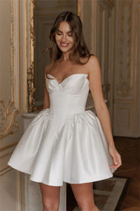Fall in love with the elegant Ella mini dress, perfect for any bride-to-be. Made with luxurious white satin fabric and designed with a strapless, sleeveless heart-shaped neckline, this dress exudes sophistication and charm. Its short length adds a modern touch, making it the ideal dress for any wedding occasion.