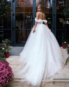 Elevate your wedding day look with our Robe Melina. This elegant ball gown boasts intricate beading, an off the shoulder sweetheart neckline, and a sleeveless tulle design. Perfect for the sophisticated bride seeking a touch of luxury and glamour.