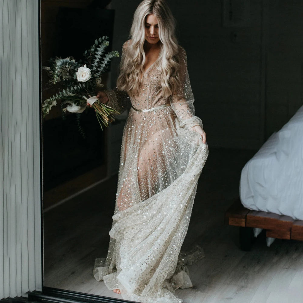 Indulge in the opulence of our Dress Carrie. This luxurious A-line gown boasts intricate beading, a see-through V-neckline, and a backless design. Adorned with sparkling Swarovski crystals and flowing layers of illusion tulle, it's a custom-made masterpiece fit for a bride's most special day.