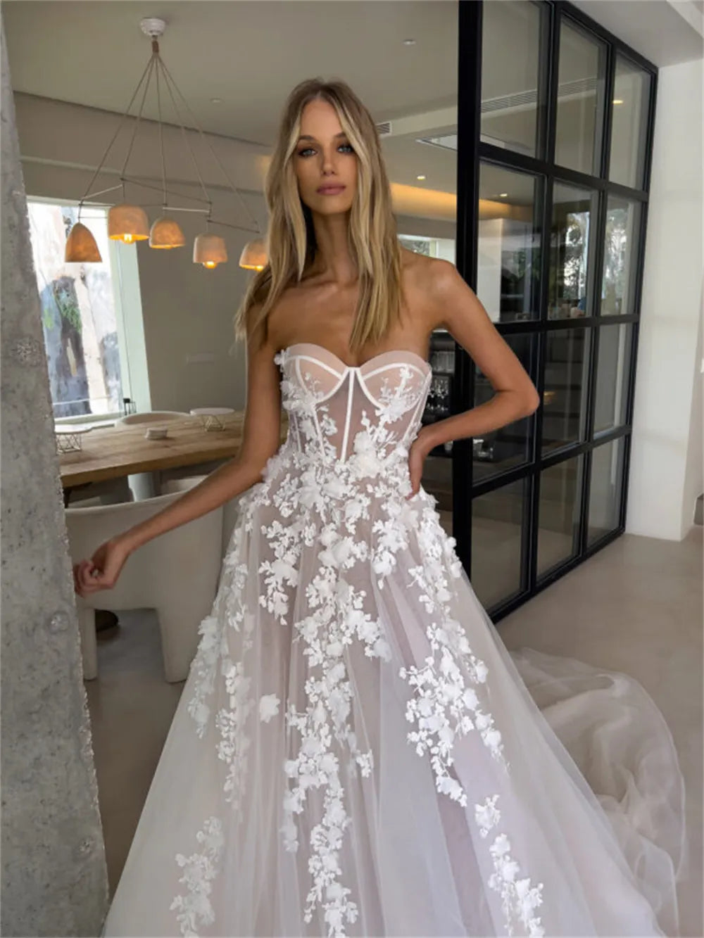 Enhance your special day with our Robe Eva. This stunning wedding dress features a flattering sweetheart neckline and elegant sleeveless design, giving you a timeless A-line silhouette. Adorned with delicate flowers, this bridal gown will make you feel like a beautiful bride on your big day.