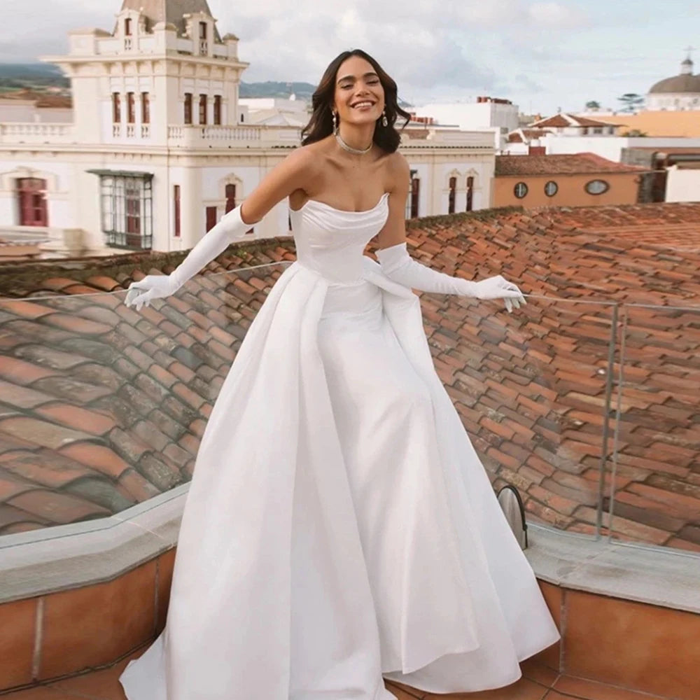 Transform into a regal vision with our Robe Bellisima. The elegant off shoulder design and detachable sleeves create a princess-like silhouette, perfect for a ball gown wedding. Crafted with luxurious detail and customizable for a flawless fit. Be a true queen on your special day.