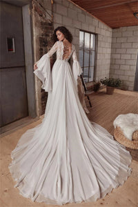 Indulge in luxury with the exquisite Dress Chamilla. This stunning wedding dress features an empire silhouette, elevated by a boat neckline and intricate lace detailing. The flowing chiffon fabric adds a touch of romance, making it the perfect choice for bridal gowns. Walk down the aisle in style and grace.