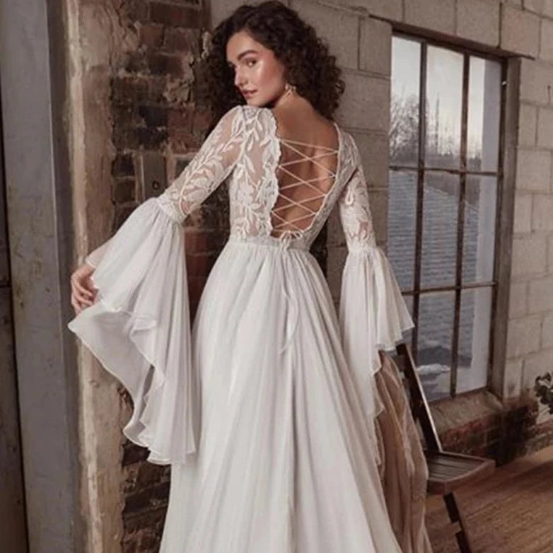 Indulge in luxury with the exquisite Dress Chamilla. This stunning wedding dress features an empire silhouette, elevated by a boat neckline and intricate lace detailing. The flowing chiffon fabric adds a touch of romance, making it the perfect choice for bridal gowns. Walk down the aisle in style and grace.