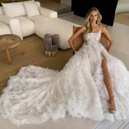 Get ready to walk down the aisle in style with our Robe Marlenne. This stunning dress features delicate flowers, a flattering square neckline, and elegant spaghetti straps. The A-line silhouette and lace detailing add a touch of romance to your special day. Say "I do" to this perfect wedding dress.