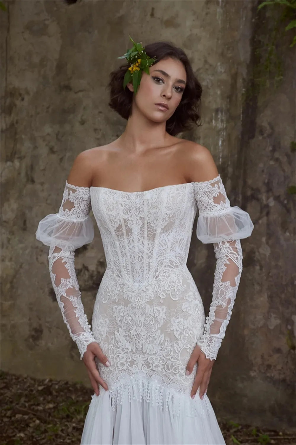 Experience true luxury with the Sabine Robe. This eye-catching floor-length gown features a beautiful mermaid silhouette with a sexy bateau neckline, a daring cut-out open back, and glimmering lace appliqués. Slay the aisle in this statement-making ensemble fit for royalty!