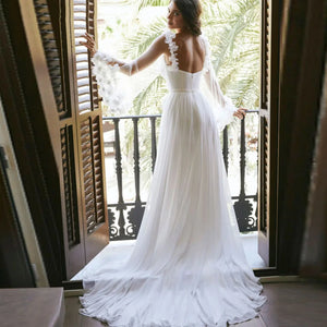 Indulge in the ultimate luxury with our Robe Charolette. Perfect for beach weddings, this gown features a stylish side split and a fashion-forward V-neck design. The puff sleeves and 3D flower details add a touch of elegance, making you feel like a true bride.
