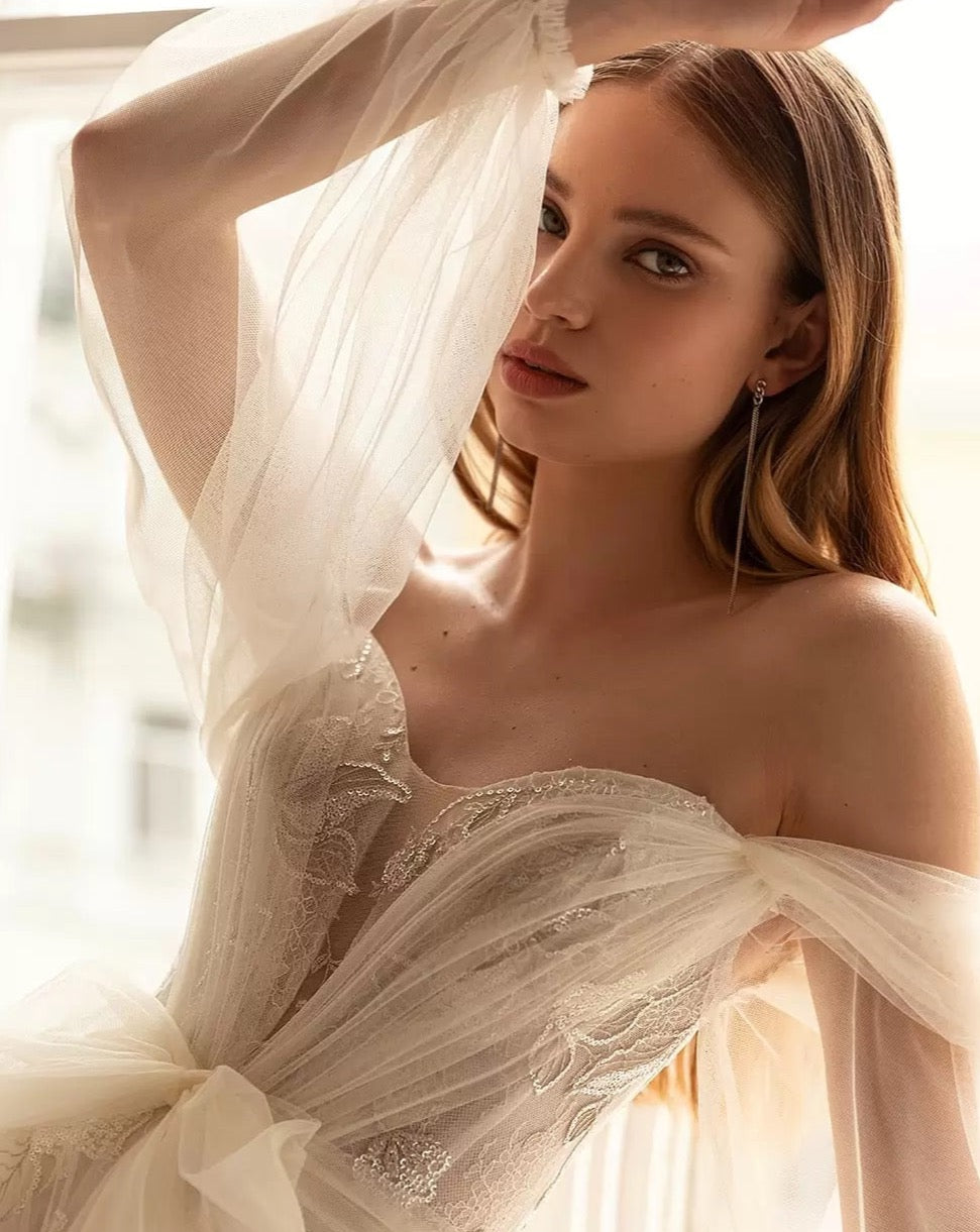 This stunning Robe Annalisa is the perfect choice for any bride-to-be. With a sweetheart neckline, full sleeve design, and beautiful bow detail, it combines elegance and femininity. The A-line silhouette flatters any body type, making you feel confident and gorgeous on your special day. Complete your look with this must-have wedding dress.