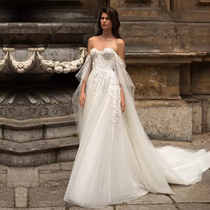 Look gorgeous for your special day in this Sydney Robe wedding dress. Off the shoulder sweetheart neckline with elegant applique detailing along the A-line tulle skirt creates a timeless and romantic look. Take the chance and live the dream in this stunning gown!