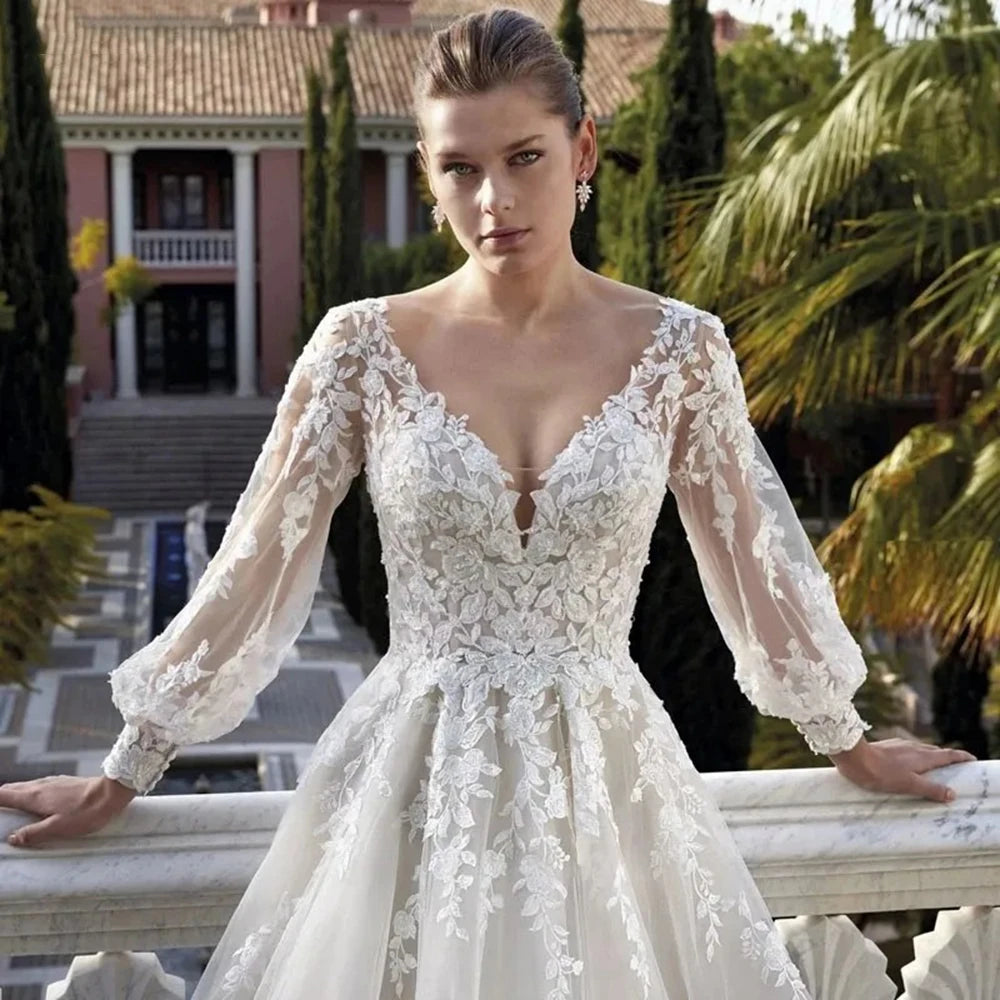 Elevate your special day with the Robe Khloe. This luxury wedding dress features long sleeves for a sophisticated touch, while the V-neck and backless design add a hint of sexiness. Indulge in the premium quality and craftsmanship of this bridal gown, making you feel like a true goddess on your wedding day.