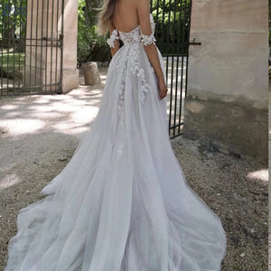 Be the picture of elegance in our Dress Isabella. This beautiful mermaid style wedding dress features an off-shoulder design, sleeveless top, and a high split for a sexy touch. With a sweetheart neckline and backless detail, you'll stun from every angle. Make a statement on your special day with this elegant bridal gown.