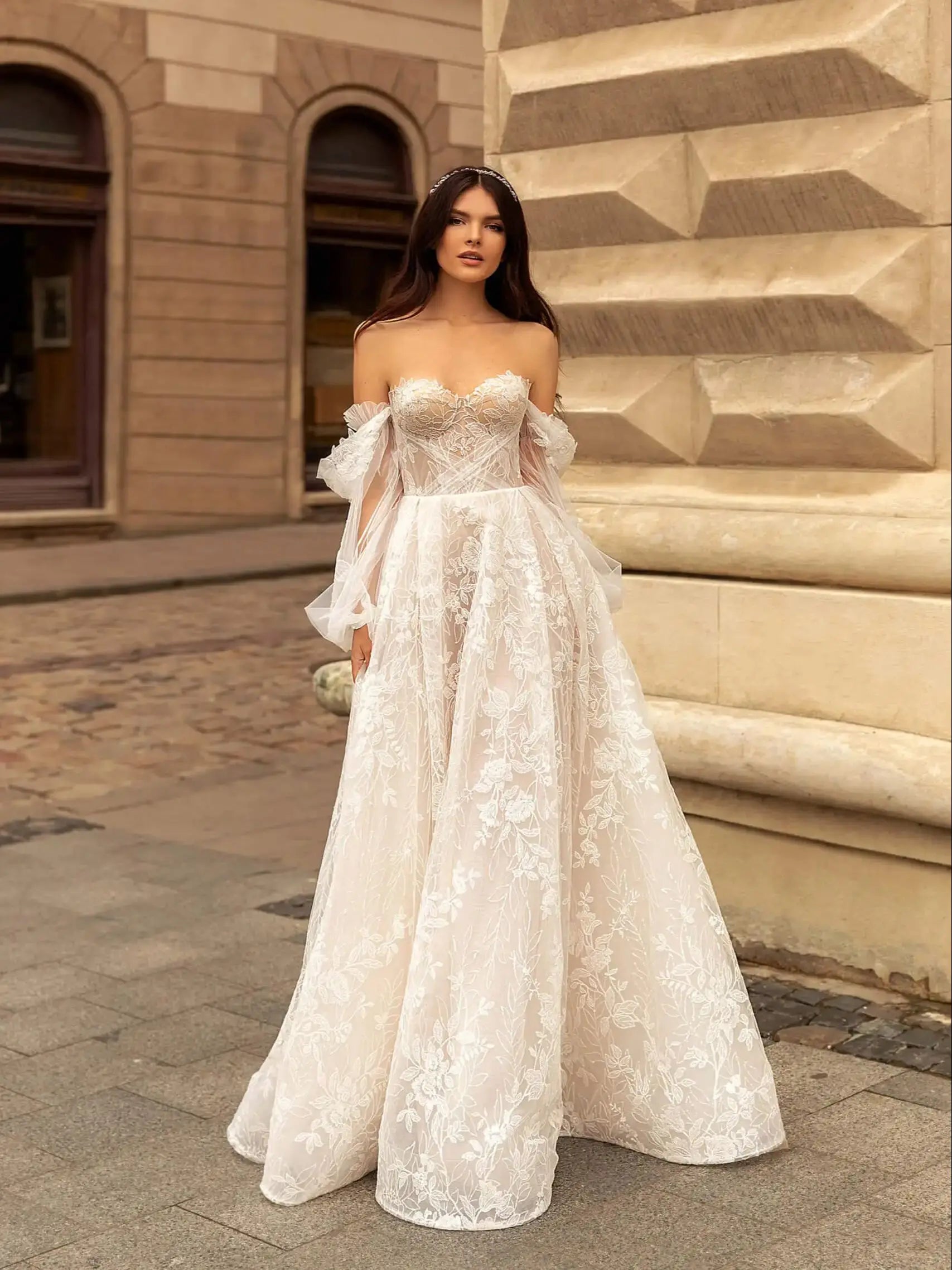 Indulge in luxury with our Robe Rachelle. This elegant wedding dress features delicate lace, long sleeves and a timeless design to make you feel like a true bride. Perfect for the contemporary woman who wants to make a statement on her special day. Step into sophistication with our Robe Rachelle.