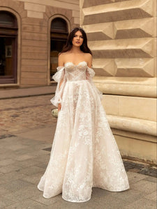Indulge in luxury with our Robe Rachelle. This elegant wedding dress features delicate lace, long sleeves and a timeless design to make you feel like a true bride. Perfect for the contemporary woman who wants to make a statement on her special day. Step into sophistication with our Robe Rachelle.