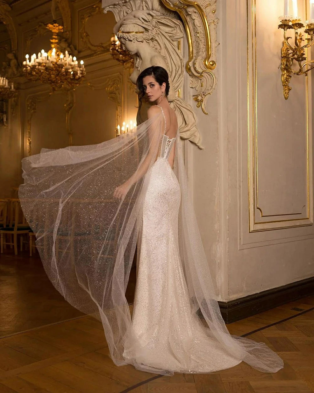 Bring a little sparkle to your special day with the Robe Linette. This mermaid style wedding gown features glittering sequins, a sweetheart corset, and playful puff sleeves. Perfect for the bride who loves to stand out and shine (literally!).